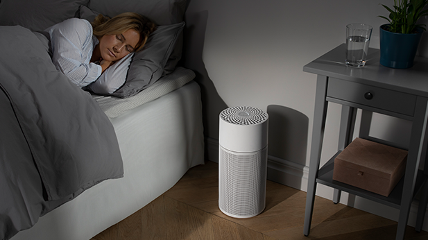 air purifier in a room with a sleeping woman