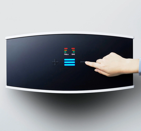 Blueair Person controlling Pro M unit through user interface on top of air purifier
