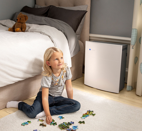Blueair Classic air purifier placed in child's room by a wall near their bed