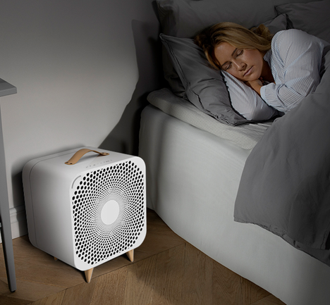Blueair person sleeping with pure fan auto next to the bed